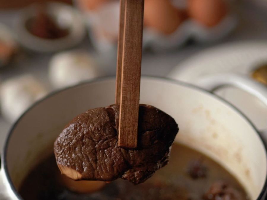 A rich meat stew simmering in a pot
